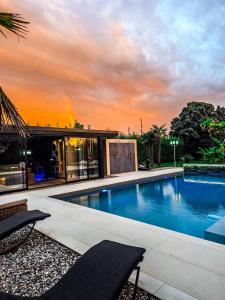 a swimming pool in front of a house at CasaKadd002LuxuryHeated Pool Garden Patio Barbeque in Civé