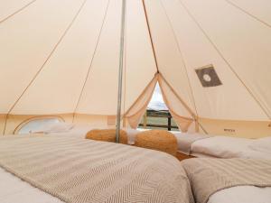 a marquee with two beds in a tent at Bell 1 in Cirencester