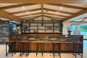a bar in a restaurant with wooden ceilings at Eastan Golf View ChiangMai in Chiang Mai
