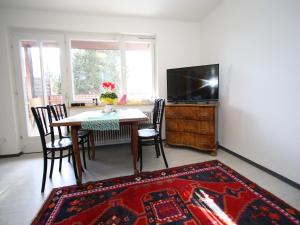 a living room with a table and a tv at Apartment in Sankt Michael near Ski Slopes in Sankt Michael im Lungau
