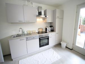 a white kitchen with a sink and a stove at Apartment in Sankt Michael near Ski Slopes in Sankt Michael im Lungau