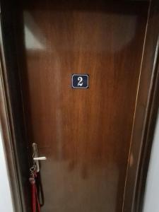 a door with a sign on it with the number on it at Galinis Rooms in Paradeísion