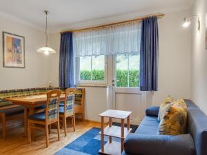 a living room with a blue couch and a table at Apartment in Kleinarl near Ski Amadé in Kleinarl