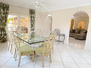 a dining room with a glass table and chairs at Amazing Villa Kameya - Mullins - Private Pool -Spa in Saint Peter