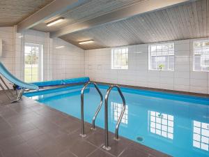a swimming pool with a slide in a building at 5 star holiday home in Øster Assels in Øster Assels