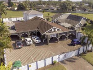 an overhead view of a house with cars parked in a parking lot at Jnc Lodge in Richards Bay