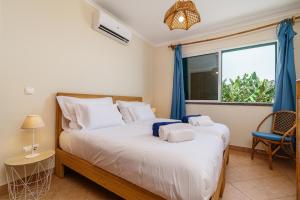 a bedroom with a large bed and a window at Conservas Loft by Madeira Dream Stays in Paul do Mar +43 photos
