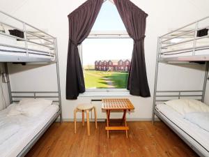 a room with two bunk beds and a table at 6 person holiday home in Hadsund in Hadsund +25 photos