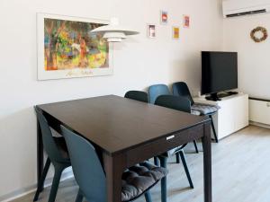 a dining room with a wooden table and chairs at 6 person holiday home in Hadsund in Hadsund