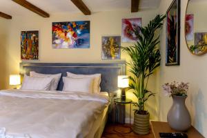 a bedroom with a bed and some pictures on the wall at Casa Joy Sighisoara in Sighişoara