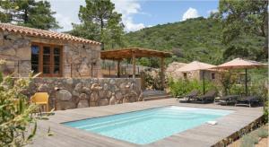 a swimming pool in a yard with a house at La BERGERIE de la CRIQUE BLEUE in Conca