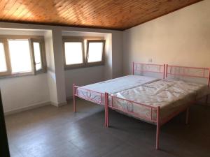 a bedroom with a bed in a room with windows at La Musica del Vento in Aggius