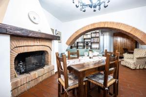 a dining room with a table and a fireplace at Il vecchio frantoio in Panicale