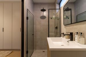 a bathroom with a sink and a shower at #AlimamaSpaces The Thando's Akaru in Johannesburg +16 photos