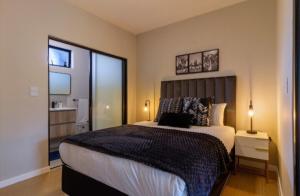 a bedroom with a large bed and a large window at #AlimamaSpaces The Thando's Akaru in Johannesburg