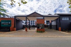 a building with a pavilion on the side of a street at #AlimamaSpaces The Thando's Akaru in Johannesburg