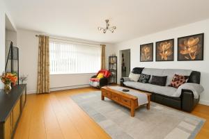 a living room with a couch and a coffee table at "Tranquil Village Hideaway Bungalow"near Kings Lynn in Kings Lynn