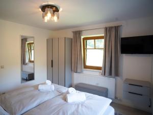 a bedroom with two beds with towels on them at Apartment Bachweg in Forstau