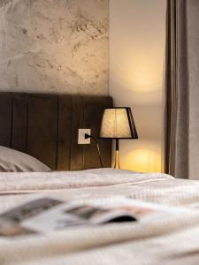 a bed with a lamp on it next to a bed with at Dani Apartment - Vinhomes Times City - Hà Nội in Hanoi