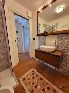 a bathroom with a sink and a mirror at Molo 2 Pila in Gressan