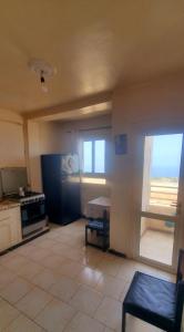 a room with a kitchen with a stove and a table at 3 bedrooms Sea View Akid Lotfi in Bir el Djir