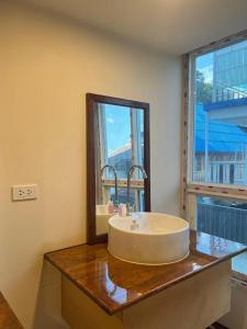 a bathroom with a sink and a mirror on a counter at Eastan Golf View ChiangMai in Chiang Mai
