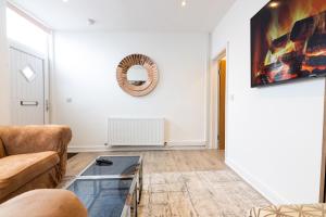 a living room with a couch and a glass table at Perfect Booking Stylish 2 Bed Home In Stockport in Manchester