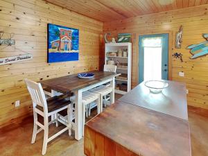 a dining room with a table and chairs in a cabin at Royal Palm in Port Aransas +25 photos