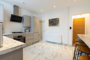a kitchen with white appliances and a counter top at Perfect Booking Stylish 2 Bed Home In Stockport in Manchester