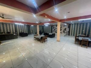 a large room with tables and chairs in a building at T Heritage Hotel in Chheonki