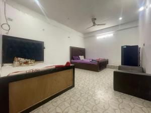 a large room with two beds and a couch at T Heritage Hotel in Chheonki
