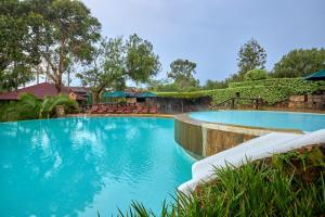 a large swimming pool with blue water at Charity Chalet in Naivasha