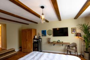 a bedroom with a bed and a tv on the wall at Casa Joy Sighisoara in Sighişoara