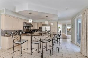 a kitchen with white cabinets and black bar stools at 309 E Jefferson Ave in Wildwood Crest