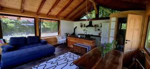 a living room with a blue couch and a table at Studio Belvedere in Mălăeşti