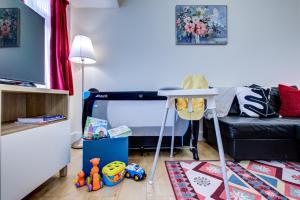 a room with a bed with a table and toys at Sleeps4-FreeParking-Pets-Wifi-Tottenham Stadium in London +42 photos
