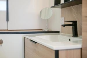 a bathroom sink with a faucet and a mirror at Joli studio avec balcon - 2 personnes in Les Sables-dʼOlonne