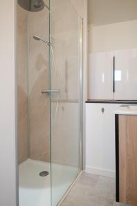 a shower with a glass door in a bathroom at Joli studio avec balcon - 2 personnes in Les Sables-dʼOlonne