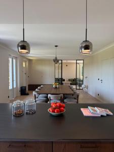 a living room with a table with tomatoes on it at Montignac Lascaux Home 