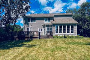 a house on a hill with a grassy yard at Blissful Wakes in South Burlington