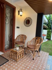 two chairs and a table on a porch at Prantara in Dehradun