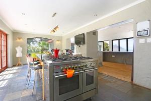 a kitchen with a stainless steel stove and a counter at Suite SolVista in Cape Town