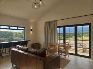 a living room with a couch and a table at Podium Farm Stay in Swellendam