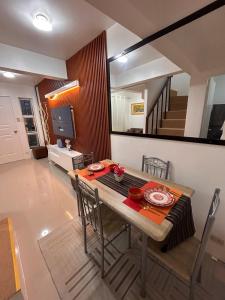 a dining room with a table with chairs and a mirror at 2-Storey Town House 2 Bedroom in Conel +20 photos