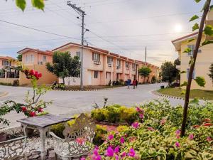 a street with a bunch of buildings and flowers at 2-Storey Town House 2 Bedroom in Conel