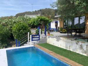 a house with a swimming pool and a patio at El Portal, 12 mins from Sitges in Olivella