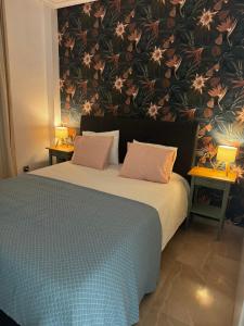 a bedroom with a large bed with a floral wallpaper at Casa Dos Palomas in Bahia de Casares +31 photos