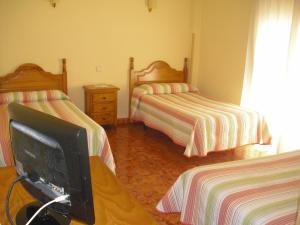 Postel nebo postele na pokoji v ubytování Hostal Sunami
