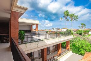 a balcony with a view of a building at D'House Seminyak in Seminyak