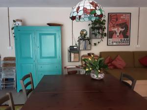a dining room with a table and a blue cabinet at SanMarco54 in Cesena +16 photos